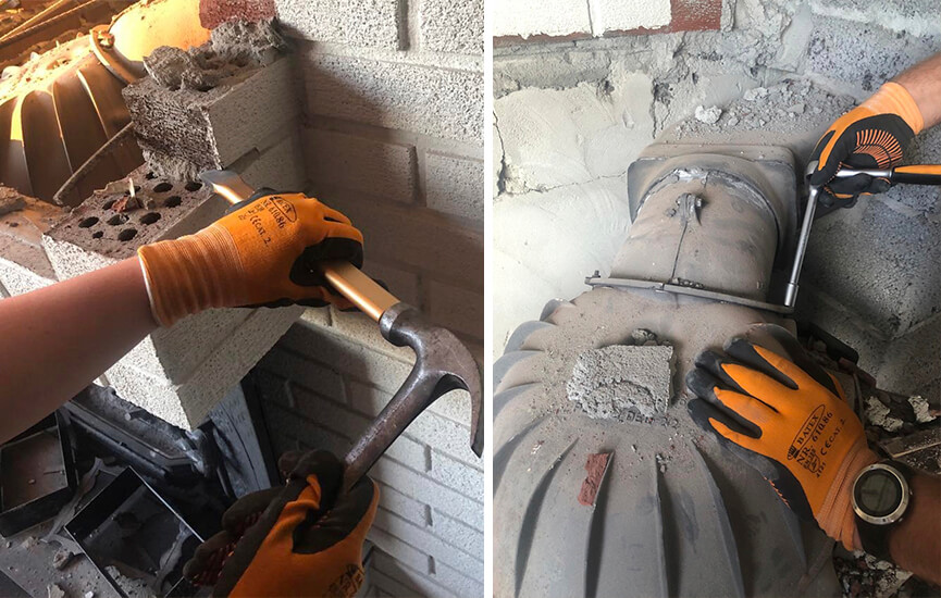 Ręce pracujące nad usunięciem starego kominka.